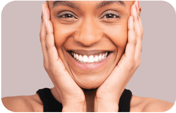 Close-up of a smiling woman with healthy teeth and clear skin.