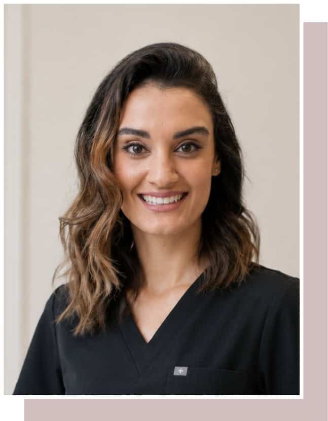 Smiling female dental professional in black scrubs at Enamelle Dental.